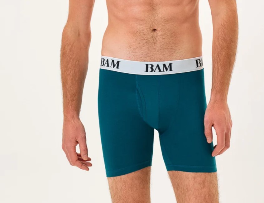 Mid-torso shot of a man wearing BAM sports trunks