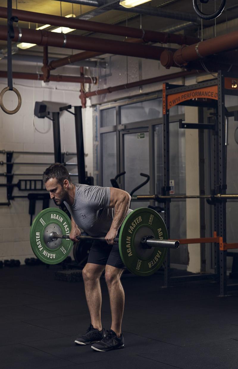 man demonstrating bent over row in full-body gym workout