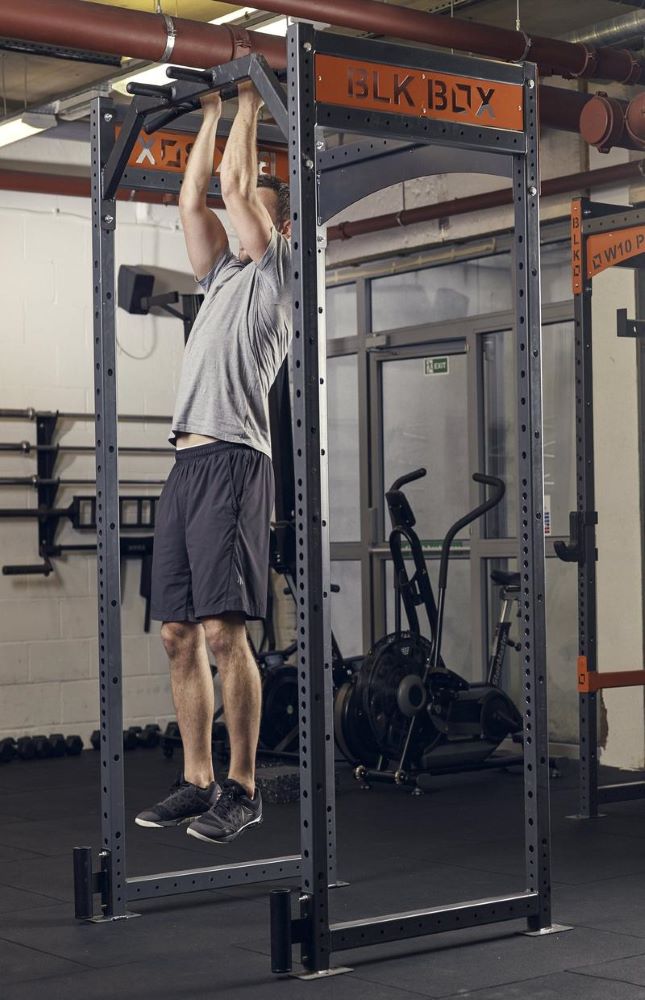 man demonstrating chin up in the gym