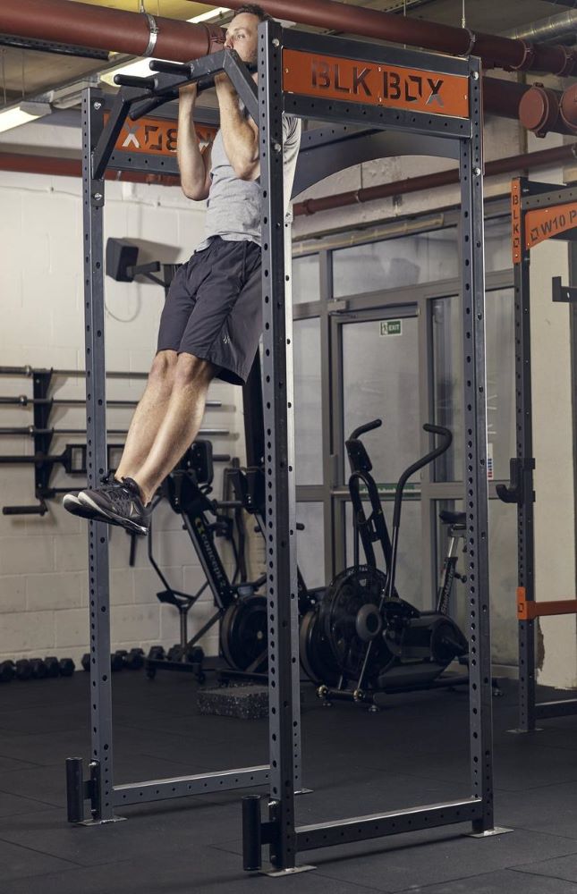 man demonstrating how to do a chin up the gym for a full body workout
