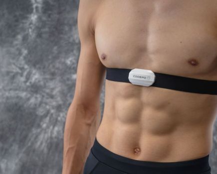 The upper torso of a man wearing a Coospo H808s heart rate monitor