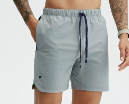 A man's lower body wearing Fabletics The One 7-Inch Shorts