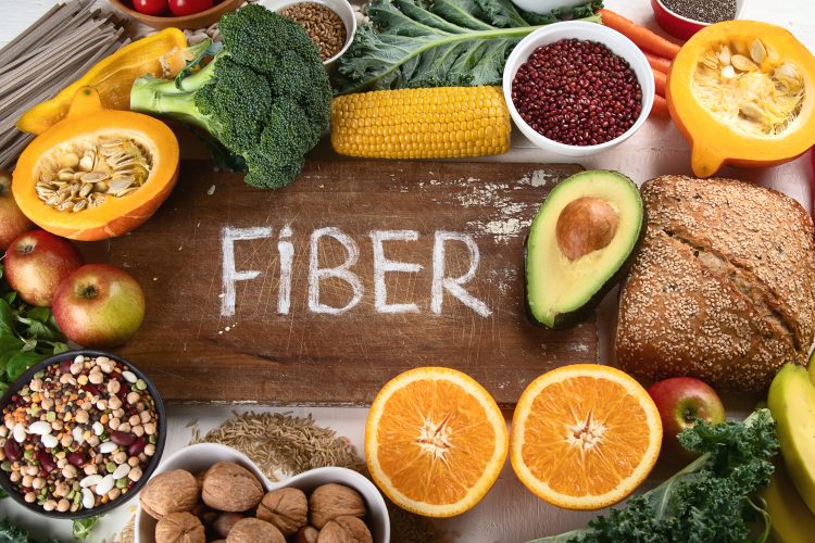 A selection of high fiber foods with the word fiber written in the middle
