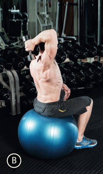 Man performing the end of the gym ball one arm overhead triceps extension - how to build bigger arm muscles