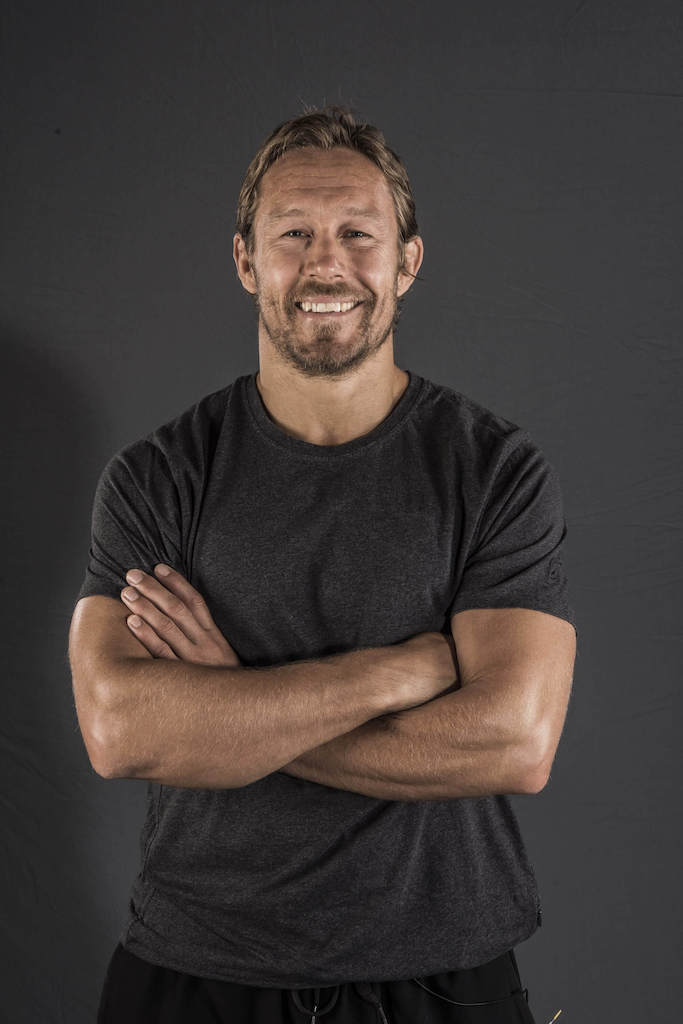 Jonny Wilkinson smiles to camera with arms folded for Men's Fitness interview 