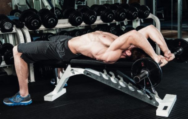 Man performing the lying triceps extension and pull-over 3 - how to build bigger arm muscles