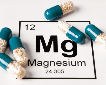 Supplement capsules with the chemical symbol for magnesium