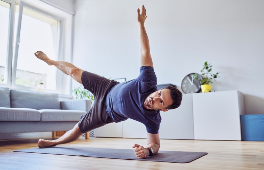 man demonstrating side star plank at home