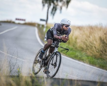 Sam Holness riding a time trial bike