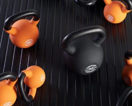 A selection of black and orange Mirafit kettlebells