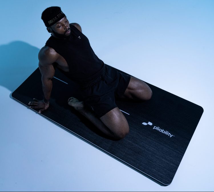 Althete performing a saddle pose on a yoga mat