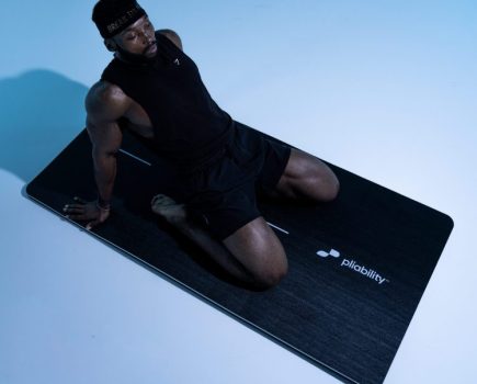 Althete performing a saddle pose on a yoga mat