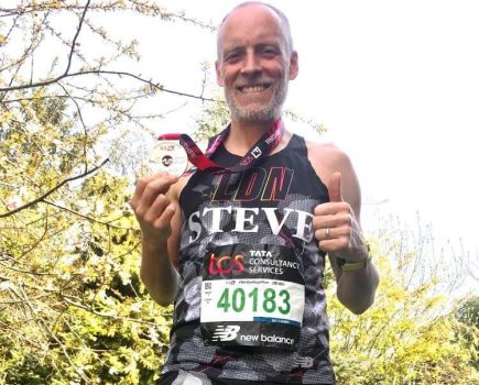 Steve Wright gives a thumbs-up and shows off his London Marathon medal