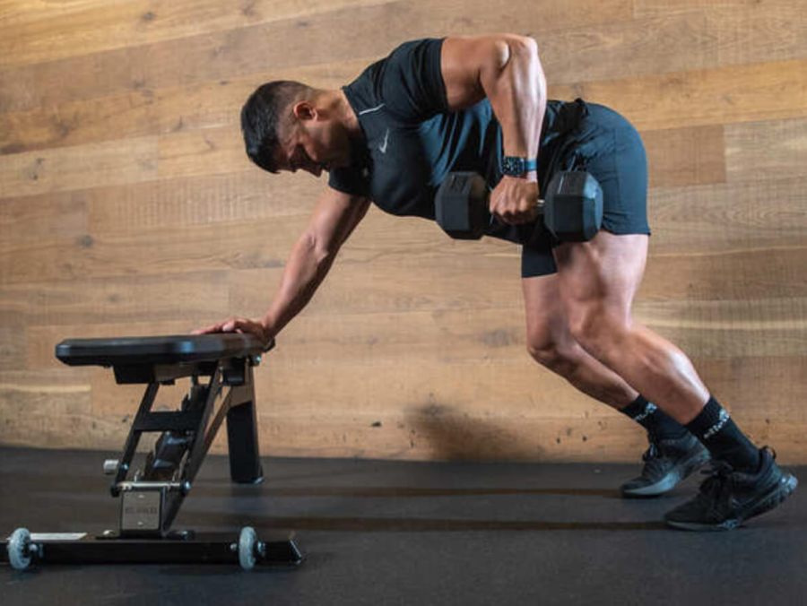 Man performing dumbbell row as part of full-body dumbbell workout