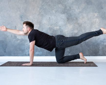 man performing bird dog lower back exercise