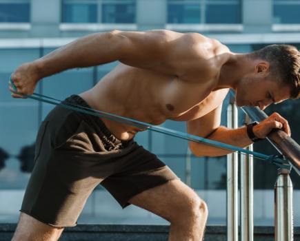 man using resistance bands for triceps workout