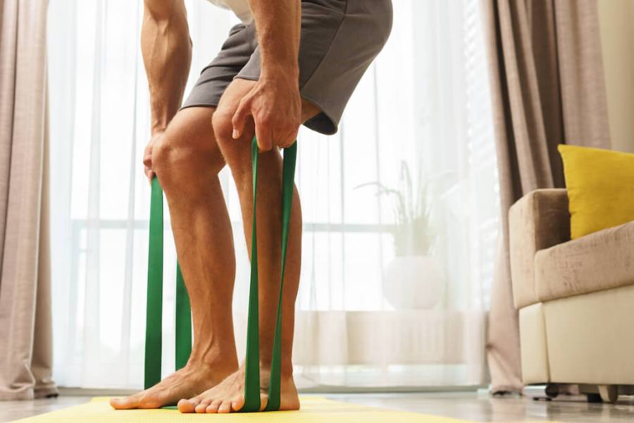 man performing resistance band row as part of resistance band upper body workout