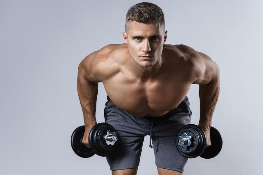 Man performing bent-over dumbbell row as part of a dumbbell-only upper-body workout