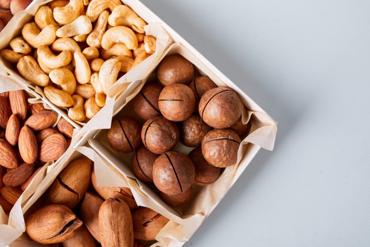 Assorted nuts in a wooden box - pecan, almond, macadamia, brazil, cashew, hazelnut