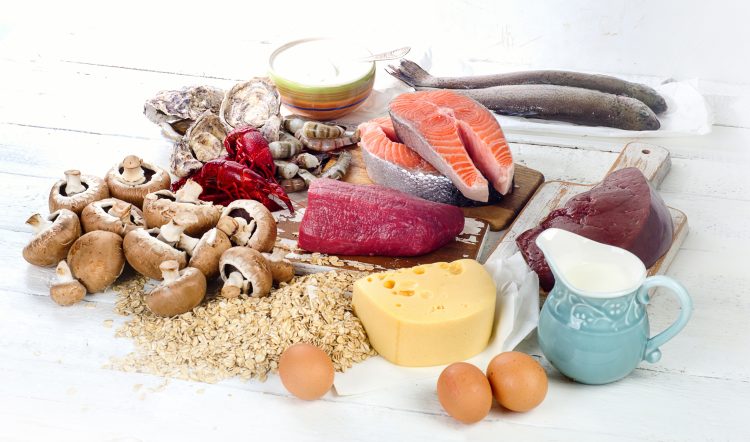 Food rich in vitamin B12 on table - including fish, cheese, eggs and oysters