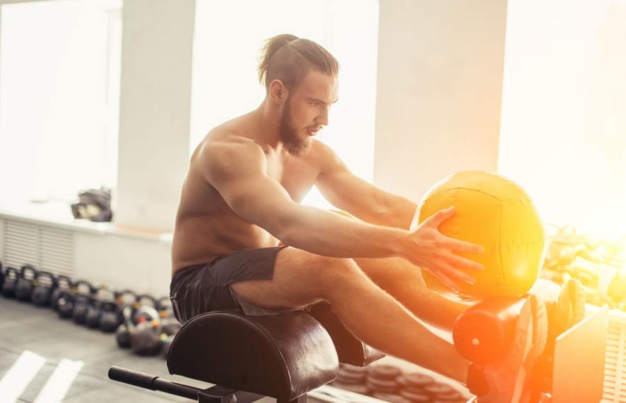 man working out in gym to burn body fat and lose belly fat
