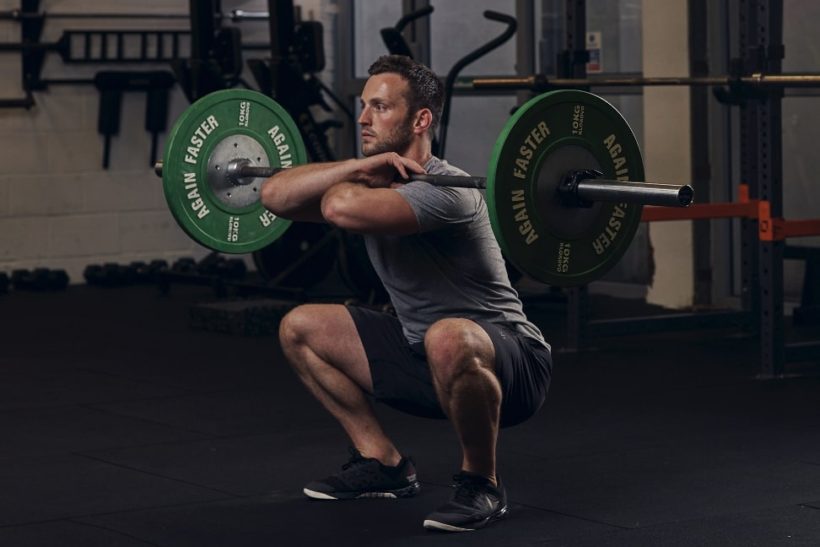 Man demonstrating a Barbell Front Squat to strengthen your legs & core