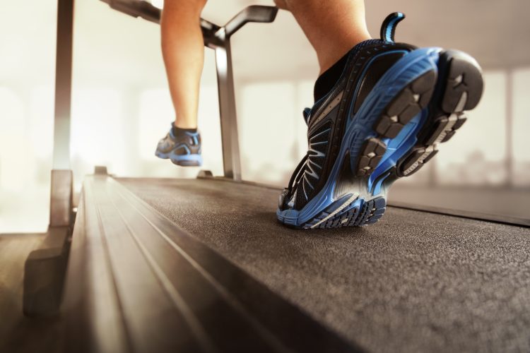 A man's lower legs running on a treadmill